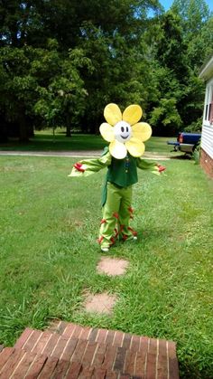 a little boy dressed up as a flower in the yard