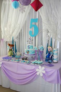 a table topped with cake and cupcakes covered in frosting