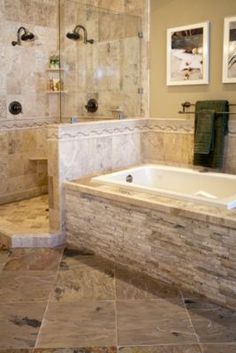 a large bathroom with a walk in shower next to a jacuzzi tub