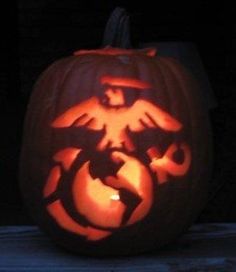 a carved pumpkin with an image of a bird on it's face in the dark