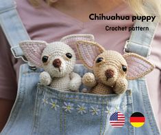 two small crocheted dogs are sitting in the pocket of a denim overalls