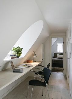 an attic converted into a bedroom and office