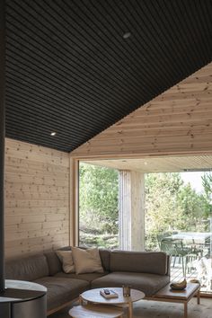 a living room with wooden walls and flooring