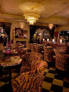 a fancy restaurant with zebra print chairs and chandeliers