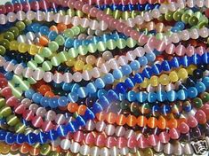 multicolored glass beads are stacked on top of each other