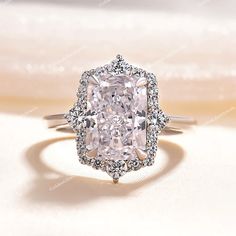 an engagement ring with a cushion cut diamond in the center