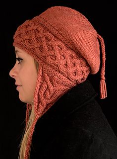 a woman wearing a knitted hat with tassels