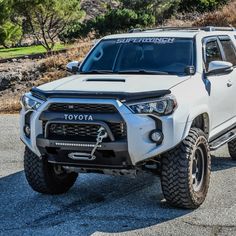 the front end of a white toyota truck