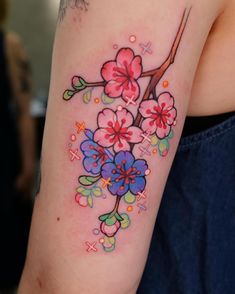 a woman's arm with flowers painted on it