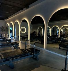 an empty gym with rows of benches and exercise equipment on the floor in front of them