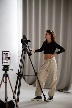 a woman standing in front of a camera