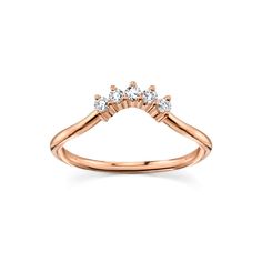 a rose gold ring with three diamonds