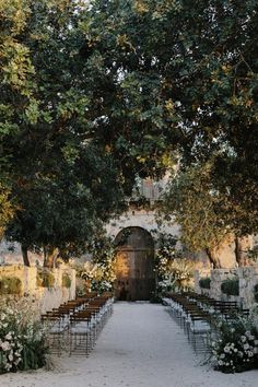 an outdoor ceremony set up with chairs and flowers