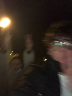 blurry image of people walking at night