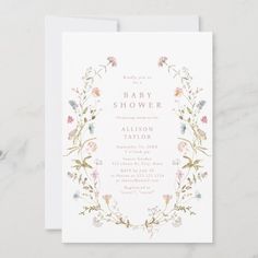 a baby shower card with flowers and leaves on the front, along with a white envelope