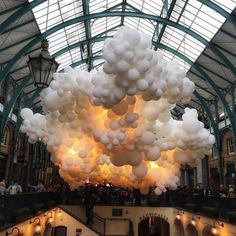 balloons are suspended from the ceiling in an indoor mall