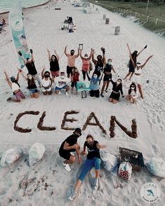 a group of people standing on top of a sandy beach next to the words clean