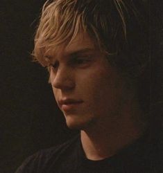 black and white photograph of a young man with blonde hair looking to his left side