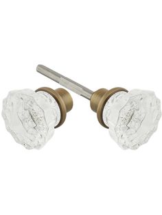 two clear glass knobs are attached to a brass plated doorknoble