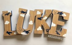 the letters are made out of wood and have airplanes on them