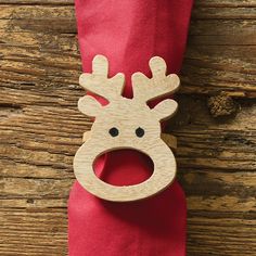 a red napkin with a wooden reindeer head on it