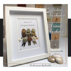 a white frame with some rocks in it and the words stones by chance on it