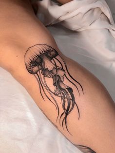 a black and white tattoo of a jellyfish