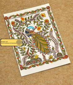 an intricately designed card with a peacock on it