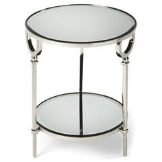 a round glass table with two shelves on the bottom and one shelf holding a mirror