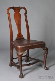 an old wooden chair sitting on top of a gray floor