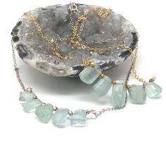 "Raw Crystal Gold  Necklace, Natural Aquamarine Necklace, Bridal Gift, March Birthstone, Natural Gemstone  A beautiful and elegant Natural Aquamarine Necklace. These necklace is perfect for layering,  and are simple enough for every day wear.  Available in gold and silver.  M A T E R I A L S ∙ A N D ∙ S I Z E  * MATERIAL Components: Chain is 14k gold filled Stones: Aquamarine   Findings: 18k gold filled  * SIZE:  Length: ~16-18inch - Nickel Free *Please note: Because we use natural stones, the stones may vary slightly in shape, shade and size. They may also contain natural inclusions.  C U R R E N T ∙ P R O D U C T I O N ∙ T I M E S All items are made to order, so please check the top of our policies page for the most up to date production and delivery times.  E X P E D I T E D ∙ S H I P P Fusion Style Emerald Necklace For Gift, Fusion Style Emerald Necklace Gift, Fusion Style Emerald Gemstone Necklace Gift, Aquamarine Necklace, Necklace Bridal, March Birthstone, Message Jewelry, Affordable Jewelry, Stunning Necklace