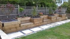 an outdoor garden area with wooden planters