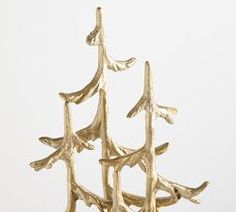 a gold tree sculpture sitting on top of a table