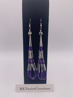 Beautiful hoop earrings made in silver and purple colors. Beads are size  11 seed bead, opaque. 3 rows of  bead strands that form 3 hoops. Length from  top of hook to bottom is 5 inches. These earrings are light weight, and a  beautiful to match any outfit and social setting.  These earrings are made with quality size 11 Czech beads, bugle beads, silver .75" cones and 3mm silver beads. Earrings will arrive in a box and padded mailer. A tracker # will be provided.  Earring are designed and made at MKNativeCreations. Lavender Adjustable Dangle Beaded Earrings, Lavender Beaded Dangle Earrings, Purple Tassel Drop Earrings With Dangling Beads, Purple Jewelry With Beaded Fringe And Round Beads, Purple Beaded Fringe Drop Earrings, Purple Beaded Earrings With Dangling Round Beads, Silver Adjustable Earrings With Beaded Fringe, Purple Beaded Dangle Tassel Earrings, Purple Beaded Long Drop Earrings