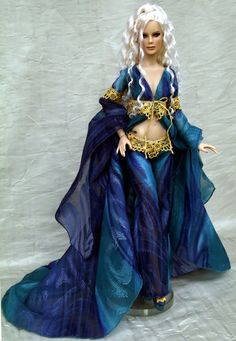 a barbie doll dressed in blue and gold