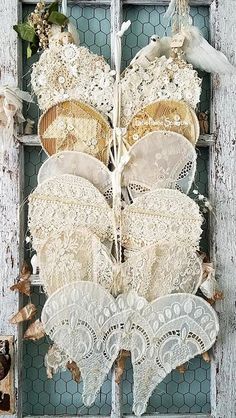 an old window with lace and flowers on it