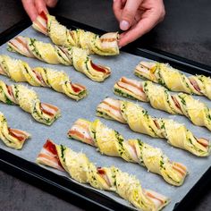 there are many sandwiches on the tray ready to be cooked in the oven or baked