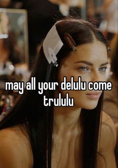 a woman with long black hair wearing a pair of scissors in her hair and the words may all your delu come truli