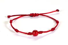 A knitted cord bracelet with a beautiful natural red coral  Knotted silky nylon cord Adjustable to any size. The cord is 1.5mm thick and the natural coral is 8mm. Wear it alone or layer it with your other favorite bracelets.    The bracelet is made with adjustable sliding knots - you will get a perfect fit with this bracelet.  Gently slide the knots away from the beads to open the bracelet.  Slip it over your hand to your wrist, then slide the knots back to the beads for a comfortable fit.  When in doubt, order a smaller size (smaller can be adjusted bigger. Bigger sizes can not be adjusted smaller). Beaded Nylon Cord Bracelet As Gift, Red Friendship Bracelets With Sliding Knot, Handmade Red Jewelry With Waxed Cord, Red Waxed Cord Bracelet With Sliding Knot, Red Adjustable Braided Waxed Cord Bracelets, Red Waxed Cord Friendship Bracelets, Adjustable Red Braided Nylon Cord Bracelet, Macrame Bracelets With Nylon Cord As Gift, Red Braided Bracelet With Sliding Knot