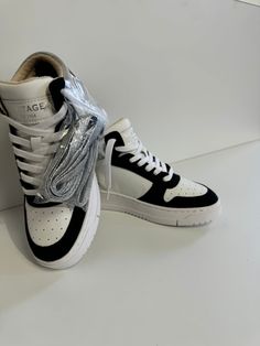 This stylish Vintage Havana sneaker features a black and white design, highlighted by a touch of chrome for added flair. Synthetic/Leather/Suede Slip-on styling No tie Traction signature outsole Fits true to size Distressed Dress, Denim Hoodie, Denim Blazer, Sweatshirt Short Sleeve, Vintage Havana, Jogger Shorts, Black And White Design, White Design, Long Sleeve Cardigan