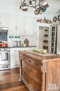 a kitchen with an island in the middle and lots of lights hanging from the ceiling