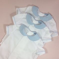 Page boy suit. Lined pale blue cotton shorts with attached braces. Elastic waist, adjustable braces. White cotton short sleeve shirt. Pleat and pin-tuck detail to front. Pale blue Peter Pan collar. Pale blue piping to collar and sleeves. Perfect little suit for any special occasion. Custom orders welcome...please ask. Shirt 6-12m Chest...29.5cm Length from nape to hem...31cm 12-18m Chest...31cm Length from nape to hem...33cm 18-24m Chest...31.5cm Length from nape to hem...37cm 2-3yr Chest...33.5 Blue Fitted Collared Set, Blue Collared Fitted Sets, Classic Cotton Sets For Summer, Classic Cotton Summer Sets, Light Blue Fitted Short Sleeve Sets, Blue Short Sleeve Sets For Daywear, Classic Blue Short Sleeve Set, Blue Cotton Shorts, Blue Peter