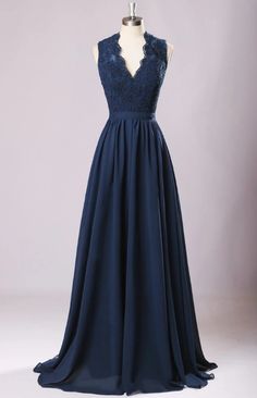 a dress on a mannequin with lace detailing and blue chiffon skirt