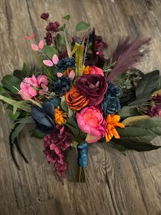 a bouquet of flowers sitting on top of a wooden floor