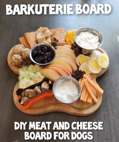 a wooden platter filled with meat and cheese