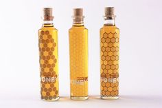 three honey bottles are lined up against a white background with the words honey printed on them