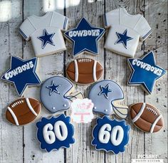 decorated cookies arranged in the shape of footballs, helmets and stars on a wooden table