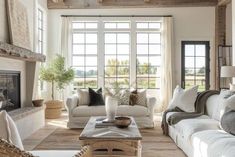 a living room filled with furniture and a fire place in front of a large window