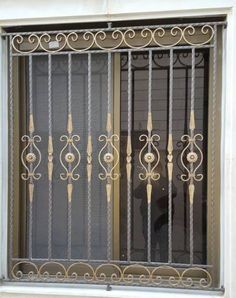 a window with iron bars and decorative designs