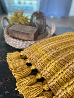 two knitted baskets sitting on top of a wooden table